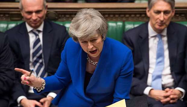 A handout photograph released by the UK Parliament shows Britainu2019s Prime Minister Theresa May as she speaks during the weekly Prime Ministeru2019s Questions (PMQs) in the House of Commons in London on Wednesday, ahead of a debate and vote on a motion of no confidence in the government.