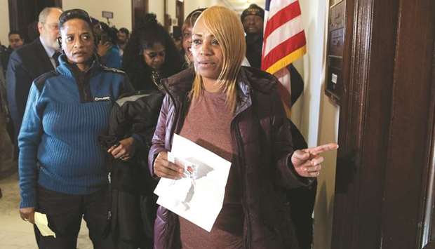 Bonita Williams, a US government employee whose son, a furloughed contract worker, helps her in paying bills, holds an unpaid electric bill alongside a group of furloughed contract workers who have not been paid during the partial government shutdown, as they present their unpaid bills to Senate Majority Leader Mitch McConnellu2019s office.