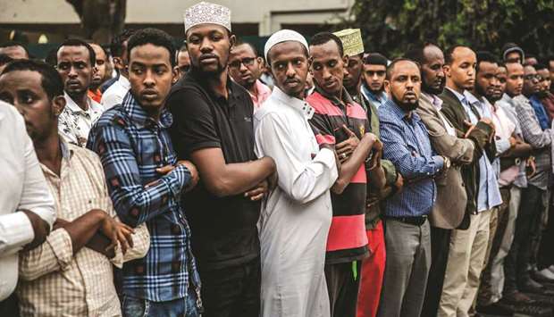People pray during the burial of Abdalla Mohamed Dahir and Feisal Ahmed, who were killed in an attack on a mosque in Nairobi.