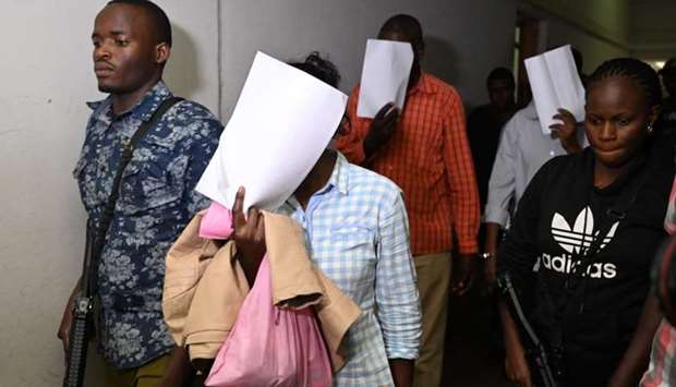 Suspects, arraigned in court in connection with an Islamist attack on a Nairobi hotel complex that left 21 dead arrive at the courthouse