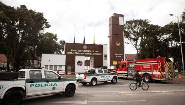 Police cars and a firetruck are seen outside General Santander Police Academy in Bogota, a day after a car bomb attack