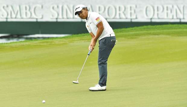 Poom Saksansin of Thailand putting during the second round of the Singapore Open golf tournament at the Sentosa Golf Club in Singapore, yesterday.
