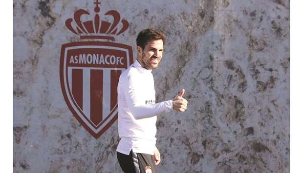 Monacou2019s Spanish midfielder Cesc Fabregas gives a thumbs up during a training session. (AFP)