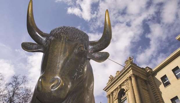 A statue of a bull is seen outside the Frankfurt Stock Exchange. Frankfurtu2019s DAX 30 ended 2.6% higher at 11,205.54 points yesterday.