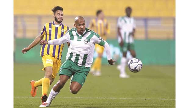 Al Gharafau2019s Mohamed Adi Monkez (left) vies for the ball with Al Ahliu2019s Nige de Jong during the QSL Cup quarter-final match yesterday. PICTURE: Othmn Khalid