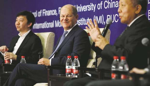 German Minister of Finance Olaf Scholz (centre) listens during a roundtable with the theme u2018International seminar on digital economy and social developmentu2019 at Renmin University in Beijing. Germany and China yesterday signed agreements to strengthen co-ordination in banking, finance and capital markets, and pledged to further open market access and deepen co-operation to broaden economic ties.