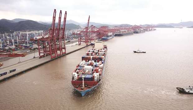 A container ship is pulled by tug boats at the Port of Ningbo-Zhoushan in Ningbo, China. By agreeing to buy more goods from the US, China may just shift its trade surplus toward other trading partners, said Tom Orlik, the chief economist for Bloomberg Economics.