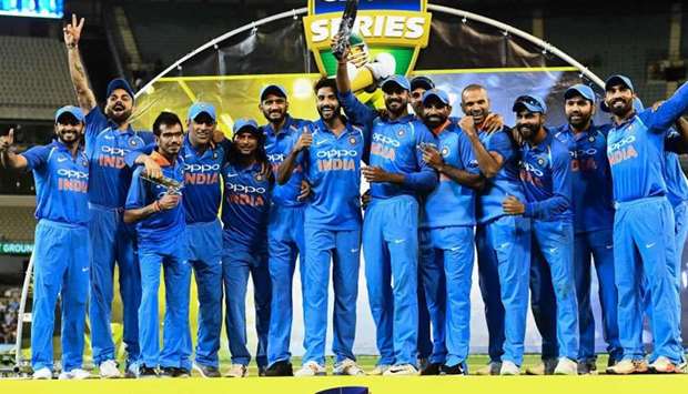 India's cricketers pose with their one-day international series trophy after defeating Australia at the Melbourne Cricket Ground