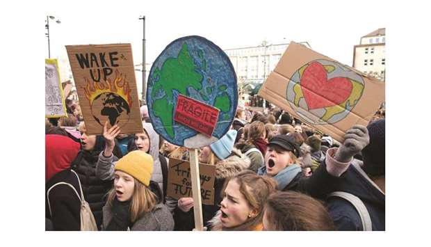 Pupils demonstrate yesterday with posters for climate protection in front of the city hall in Hamburg, northern Germany.