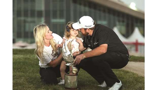 Shane Lowry of Ireland (R) poses with his wife Wendy Honner and daughter Iris after winning the Abu Dhabi Golf Championship yesterday.