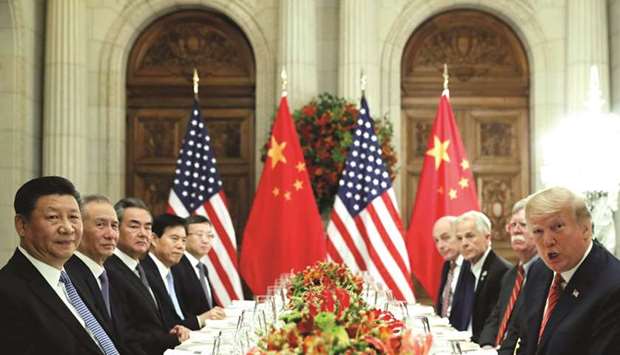 US President Donald Trump, Secretary of State Mike Pompeo, Trumpu2019s national security adviser John Bolton and Chinese President Xi Jinping attend a working dinner after the G20 leaders summit in Buenos Aires, Argentina (file). A continuing threat of tariffs hanging over commerce between the worldu2019s two largest economies would mean a deal would not end the risk of investing in businesses or assets that have been impacted by the trade war.