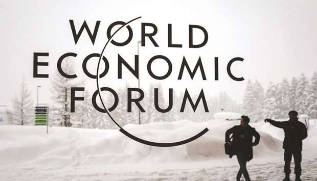 In the file photo taken on January 22, 2018 a security guard shows the way to a man outside of the Davos Congress Centre under snow ahead of the opening of the World Economic Forum (WEF) annual meeting, in Davos, eastern Switzerland. This year, Domestic political strife is forcing US President Donald Trump and UK Prime Minister Theresa May to stay home.