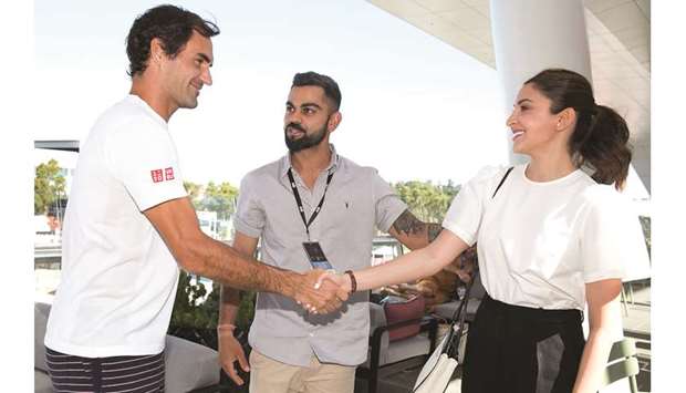 Swiss tennis star Roger Federer (left) meets Indian cricket captain Virat Kohli (centre), and his wife and actress Anushka Sharma at the Australian Open in Melbourne yesterday. (AFP)