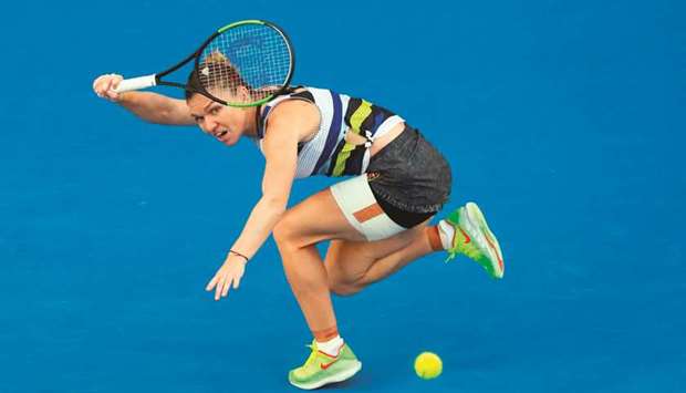 Romaniau2019s Simona Halep hits a return against Venus Williams (not pictured) of the US during their match on day six of the Australian Open in Melbourne yesterday. (AFP)