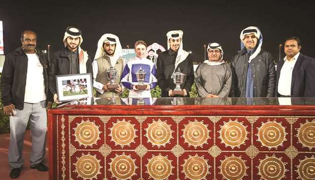 Qatar Racing and Equestrian Clubu2019s (QREC) Racing manager Abdulla Rashid al-Kubaisi (third from right) with the winners of the Muaither Cup after Anima Rock won the 1000m feature at Al Rayyan Park yesterday. PICTURES: Juhaim