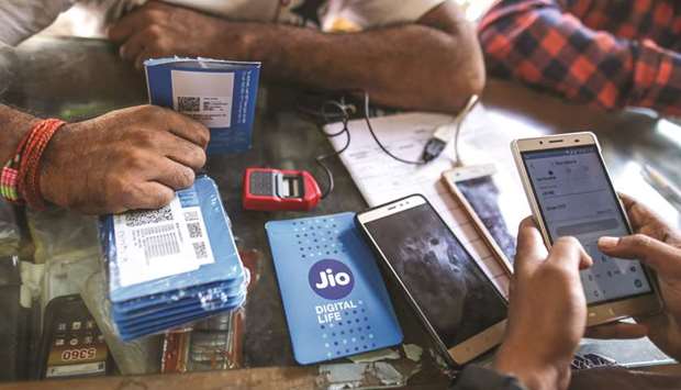 A mobile vendor fills digital form of Reliance Jio, Reliance Industriesu2019 mobile network inside his mobile shop in Mumbai. Jio led the subscription race in November 2018 adding around 880.10mn subscribers across the country.