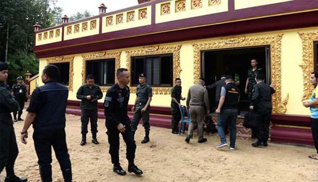 Police investigators inspect Rattanaupap temple in Narathiwat province following an attack by black-clad gunmen that killed two Buddhist monks. Gunmen in Thailand's deep south shot dead two Buddhist monks and wounded two others inside a temple
