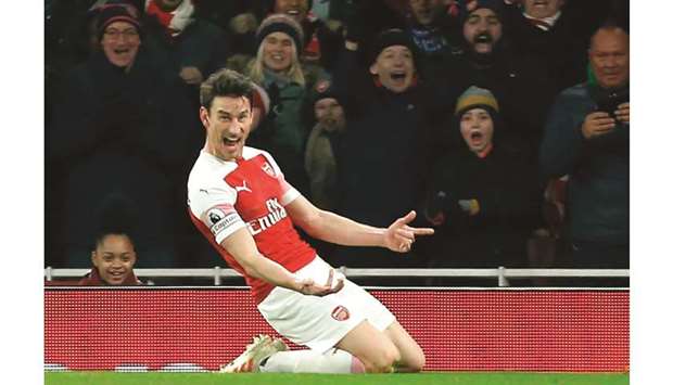 Arsenalu2019s French defender Laurent Koscielny celebrates after scoring their second goal against Cheslea in London yesterday.