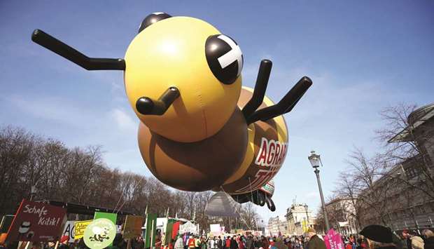 A bee shaped balloon sporting the words u2018agriculture industry killsu2019 is held by protesters during a rally yesterday for climate justice, animal welfare, low impact farming, and good food in Berlin.