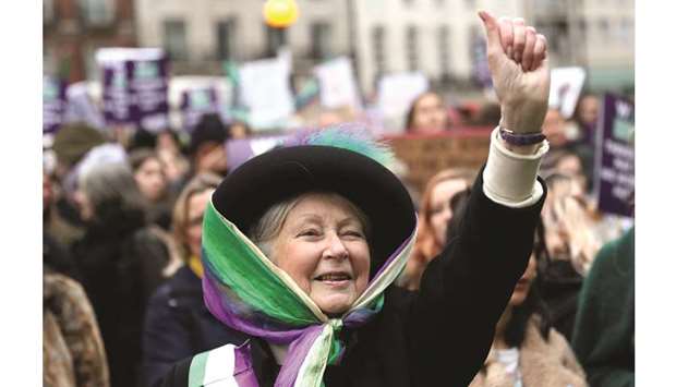 A woman dressed as suffragette gestures in London during the Womenu2019s March calling for equality, justice and an end to austerity.