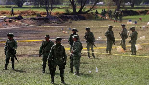 Soldiers are seen at the site where a fuel pipeline ruptured by suspected oil thieves exploded, in the municipality of Tlahuelilpan, state of Hidalgo, Mexico