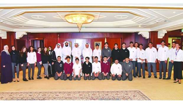 Dr Abdulbasit Ahmad al-Shaibei and senior QIIB executives with students of Qatar Academy.