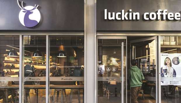 A customer enters a Luckin Coffee outlet in Beijing. Luckin Coffee plans to build a high tech-driven shop every three and a half hours to dethrone the US giant, Starbucks.