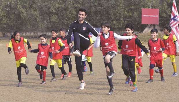 Pakistani children exercise with local coaches at Atletico De Madrid clubu2019s new facility in Lahore. (AFP)