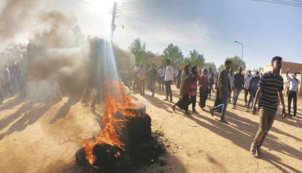 Sudanese demonstrators burn tyres as they participate in anti-government protests in Omdurman, Khartoum, yesterday.