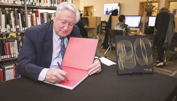 Dr Donald Baker, executive dean of VCUarts Qatar, signs the book.