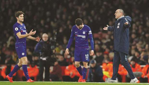 Chelsea manager Maurizio Sarri (right) reacts as Marcos Alonso and Mateo Kovacic look on after their loss to Arsenal. (Reuters)