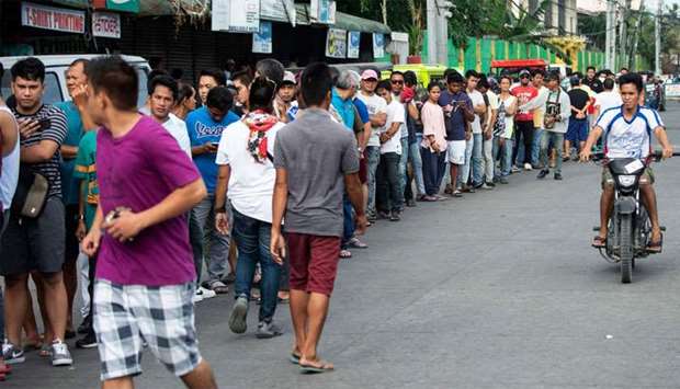 People line up to cast their ballot at a voting precinct in Cotabato on the southern Philippine island of Mindanao
