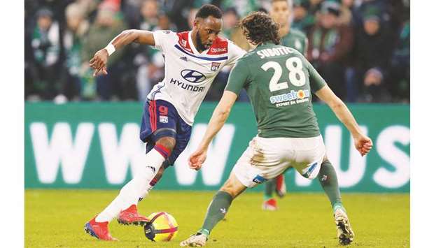 Lyonu2019s Moussa Dembele (left) attempts to get past Saint-Etienneu2019s Neven Subotic  during the French Ligue match on Sunday night. (Reuters)