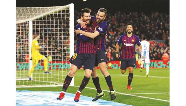 Barcelona superstar Lionel Messi celebrates with teammate Jordi Alba after scoring against Leganes on Sunday night. (Reuters)