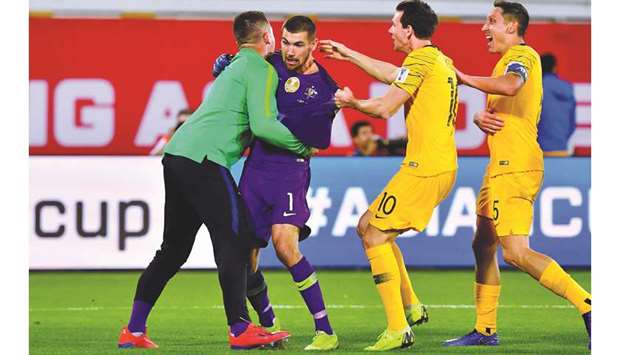 Australiau2019s goalkeeper Maty Ryan (second left) celebrates with teammates after his shootout heroics helped his team to win over Uzbekistan in the AFC Asian Cup Round of 16 match at the Khalifa bin Zayed Stadium in Al Ain, UAE, yesterday. (AFP)
