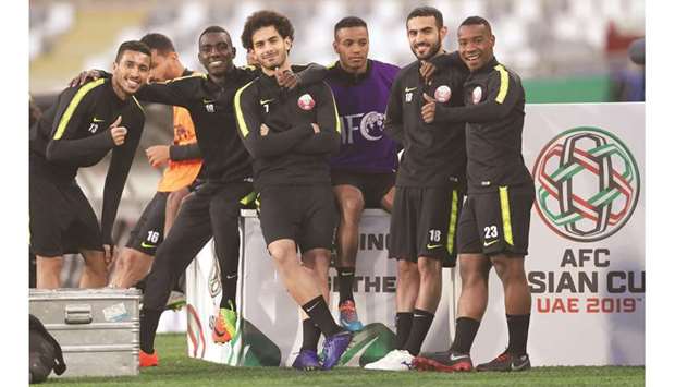 Raring to go: Asian Cup top scorer Almoez Ali (second from left) poses with his teammates during a training session in Abu Dhabi yesterday. At bottom, coach Felx Sanchec and player Ali Afif attend a pre-match press conference.
