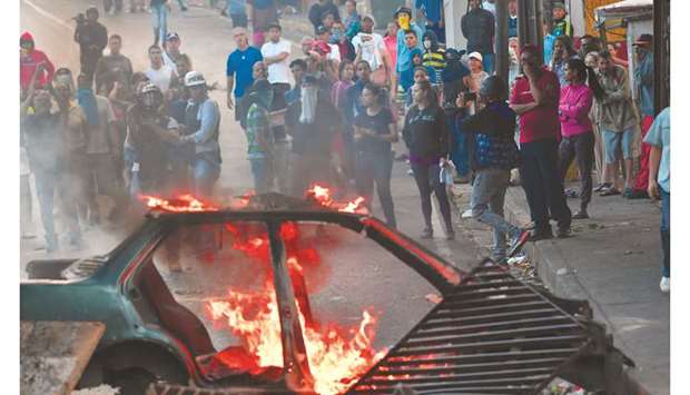Venezuelans protest outside the Cotiza Bolivarian National Guard headquarter in Caracas.