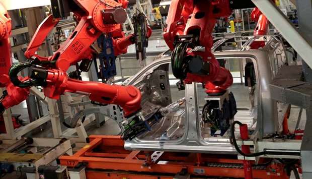 Robots work on the cab of a 2019 Ram pickup truck at the Fiat Chrysler Automobiles (FCA) Sterling Heights Assembly Plant in Sterling Heights, Michigan, US, on October 22, 2018.