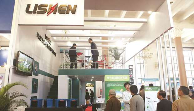 Visitors are seen at the booth of Lishen Battery at an energy expo in Beijing. US electric vehicle maker Tesla has held talks with  Lishen to supply batteries for its new Shanghai factory, sources said yesterday.