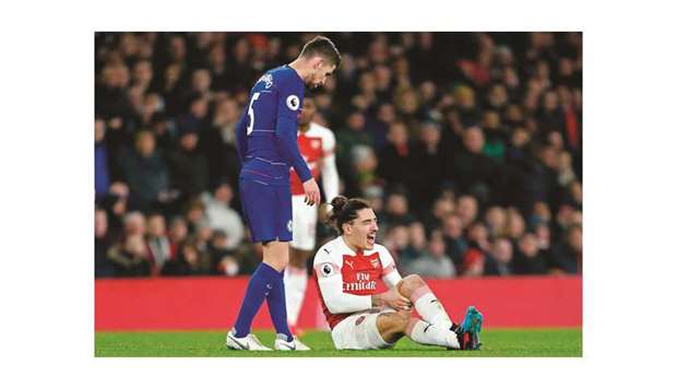 Arsenalu2019s defender Hector Bellerin reacts in pain after picking up an knee injury  during the Premier League football match against Cheslea on Saturday. (AFP)