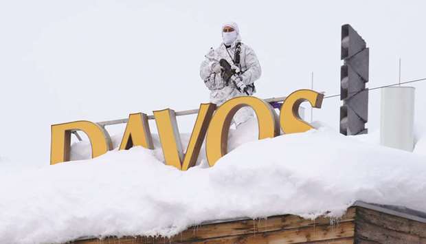 An armed member of the Swiss police watches from the snow-covered roof of the Hotel Davos ahead of the World Economic Forum (WEF) in Davos. In the 12 months since US President Donald Trump visited the WEF, he has launched a trade war with China, slapped tariffs on Europe, weighed in on Prime Minister Theresa Mayu2019s Brexit deal, expressed understanding for Franceu2019s u201cYellow Vestu201d protests against President Emmanuel Macron and threatened to u201cdevastateu201d Turkeyu2019s economy.
