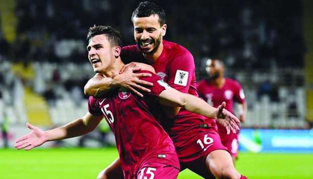 Qatar's Bassam al-Rawi (left) celebrates his goal against Iraq with Boualem Khoukhi during their Asian Cup round of 16 match in Abu Dhabi