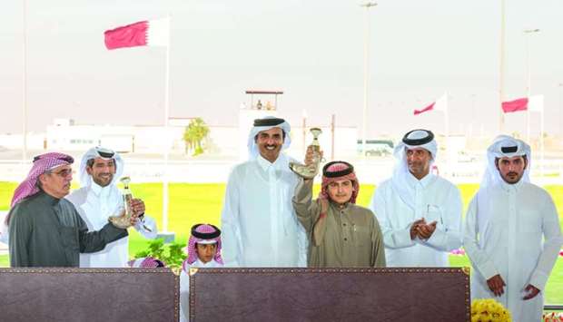 His Highness the Amir Sheikh Tamim bin Hamad al-Thani on Wednesday crowned the winners of the eight main races of the Founder Sheikh Jassim bin Mohamed bin Thani Camel Festival for purebred Arabian camels, which took place at Al Shahaniya racetrack. The Amir awarded the winners of the final four races of the category for camels aged more than seven years owned by sheikhs. Al Shahaniya camels won the four races. The camels Wesal, Al Hathra, Munawer, and Marmar all won the awards in the four races. In the same category for camels owned by tribe members, the Amir awarded Said Mohamed Zayed al-Khayarain, owner of the camel Sahm the silver spear, and two silver daggers for Nasser Mohamed Said al-Aida, owner of Al Udeid and Salem Nasser Said al-Aida, the owner of Lusail. The races were attended by sheikhs, tribe members, and lovers of Al Hejen sports.