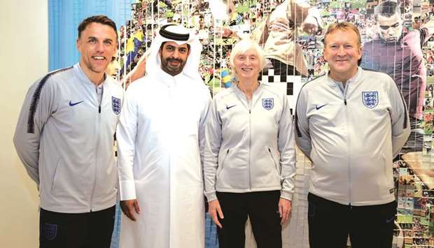 England womenu2019s team head coach Phil Neville (left), Baroness Sue Campbell (second right), Head of England Womenu2019s Football, and David Faulkner, Head of Womenu2019s Performance with Nasser al-Khater, the SCu2019s Chief of Tournament Readiness & Experience Group during their visit to the SCu2019s Legacy Pavilion.