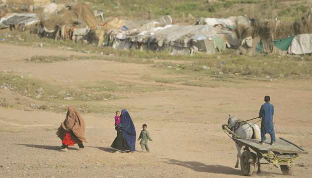 Members of an Afghan family are seen near a refugee camp on the outskirts of Islamabad.