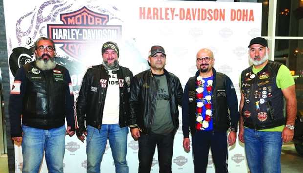 Qatari biker Khaled al-Jaber (2nd, right) with Harley Owners Group u2013 Qatar officials.