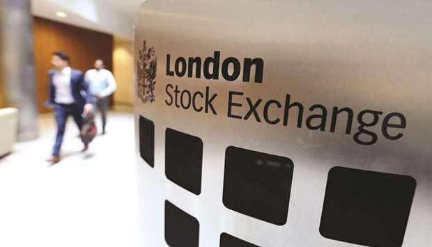 Visitors pass a sign inside the main atrium of the London Stock Exchange Group headquarters. The FTSE closed 0.9% down at 6,842.88 points yesterday.