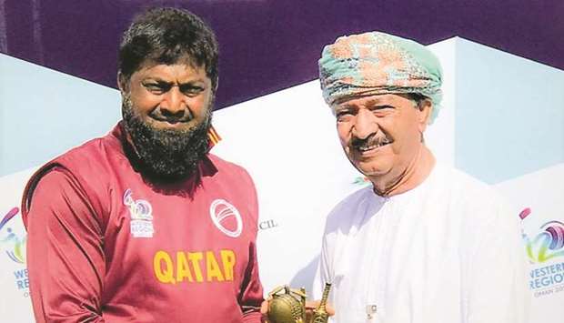 Qatar captain Inam-Ul-Haq (left) receives his man-of-the-match award.