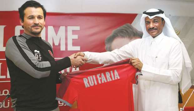 Portuguese coach Rui Filipe Faria (left) shakes hands with Al Duhail SCu2019s vice president Khalifa Khamis al-Sulaiti during a press conference in Doha yesterday. (AFP)