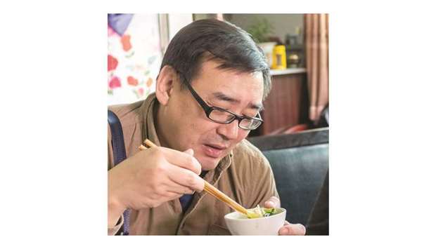Yang Hengjun, author and former Chinese diplomat, who is now an Australian citizen, eats in an unspecified location in Tibet, China, in this file photo.